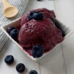 Blueberry frozen yogurt in a white bowl