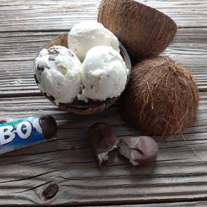 Bounty ice cream in a bowl on a wooden table