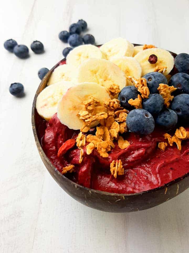 A bowl of mixed fruit nice cream on a white table